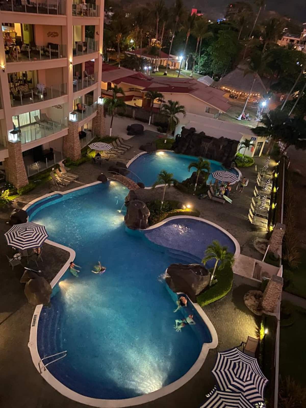 Illuminated resort-style pool at Diamante del Sol in Jaco